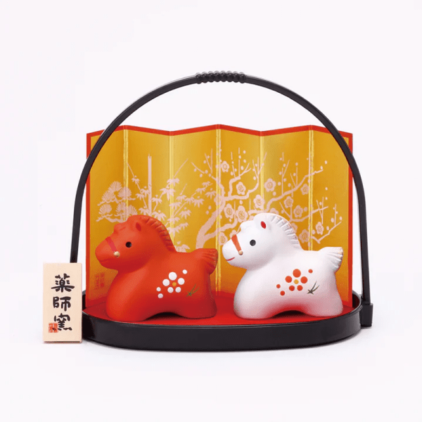 Yakushigama Red and white horse figurine with a small basket